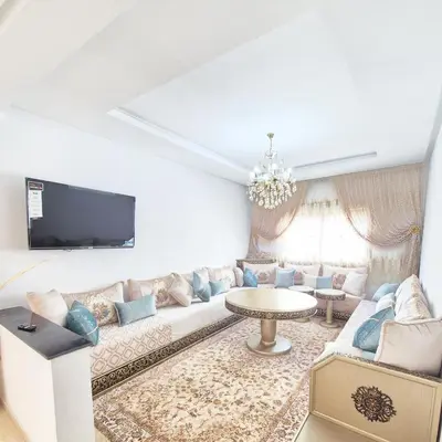 a living room with a couch and a table at Appartement familial au quartier des Hôpitaux in Casablanca