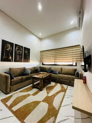 a living room with a couch and a table at Residence Carlton House2 STUDIOS in Roches Noires