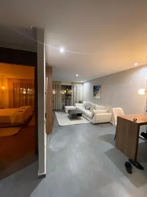 a living room with a couch and a table at Residence Carlton House2 STUDIOS in Roches Noires