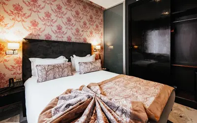 a bedroom with a large white bed and red wallpaper at The Fourteen Luxury Boutique Hotel & SPA in Casablanca