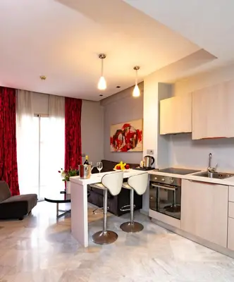 a kitchen with a table and chairs in a room at The Fourteen Luxury Boutique Hotel & SPA in Casablanca