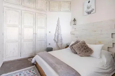 a bedroom with a white bed and a christmas tree at Charming Moroccan Studio, Breathtaking View in Casablanca