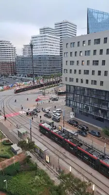 a city street with trains and cars and buildings at Luxury Appart Finance City in Casablanca