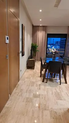 a dining room with a table and chairs in a room at Luxury Appart Finance City in Casablanca