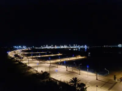 a parking lot with street lights at night at Chambre Cosy - Accès Côte et Plage Mohammedia, Centre-Ville Mohammedia à Pied - Résidence 3 Mars in Mohammedia