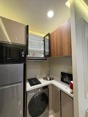 a small kitchen with a stove and a washer at Premium Studio Oasis Secure Parking High Speed Fiber Wifi Luxoria Oasis Residence Near CFC & 70p Smart TV in Casablanca