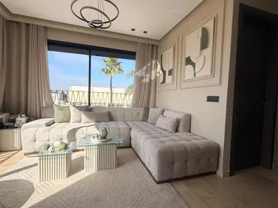 a living room with a couch and a large window at Premium Studio Oasis Secure Parking High Speed Fiber Wifi Luxoria Oasis Residence Near CFC & 70p Smart TV in Casablanca