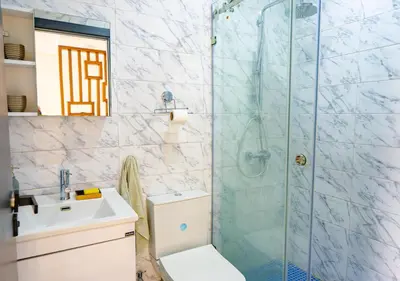 a bathroom with a shower and a toilet and a sink at Studio Balcony Netflix, Near CFC, Parking in Casablanca