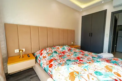 a bedroom with a large bed with a colorful bedspread at Studio Balcony Netflix, Near CFC, Parking in Casablanca