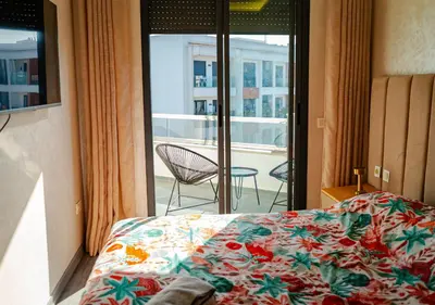 a bedroom with a bed and a view of a balcony at Studio Balcony Netflix, Near CFC, Parking in Casablanca