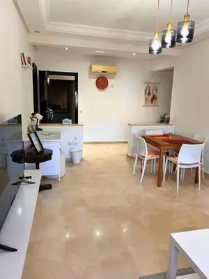 a kitchen and dining room with a table and chairs at Charming apartment near Mohammedia station in Mohammedia