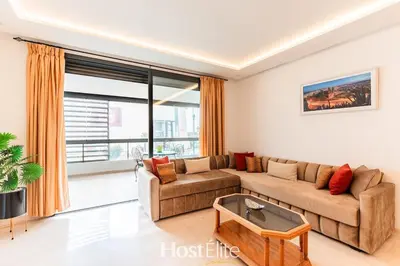 a living room with a couch and a table at CFC Elegance & Terrace & Fitness & Parking in Casablanca