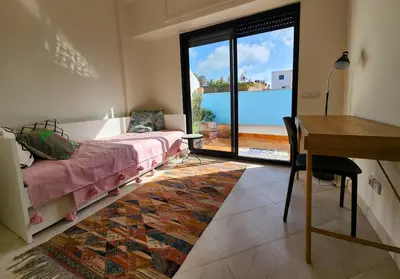a bedroom with a bed and a desk with a view at Private and sunny apartment in central Casa in Casablanca
