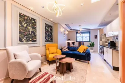 a living room with a blue couch and two chairs at Give Essalam Design & Patio & Clim & 2P in Casablanca