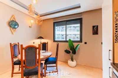 a dining room with a table and chairs and a window at Give Essalam Design & Patio & Clim & 2P in Casablanca
