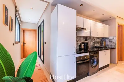 a kitchen with white cabinets and a dishwasher at Give Essalam Design & Patio & Clim & 2P in Casablanca