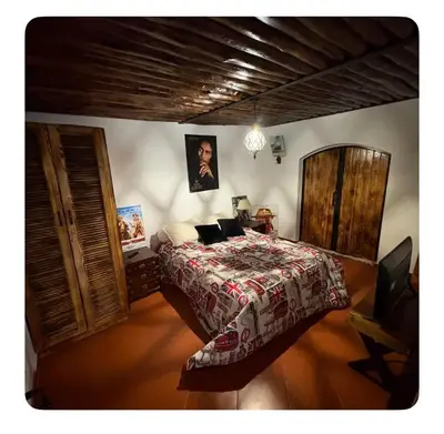 a bedroom with a bed with a comforter at La Hacienda De Morafia in Bouskoura