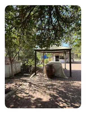 a table under a canopy on a brick sidewalk at La Hacienda De Morafia in Bouskoura