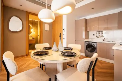 a kitchen and dining room with a table and chairs at Studio chic & moderne - Les Princesses - Parking in Casablanca