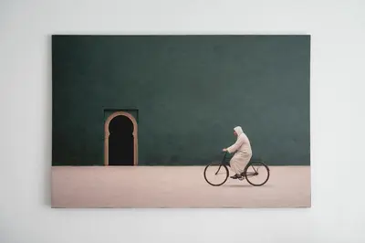 a man riding a bike in front of a green wall at Résidence Happy Living in Casablanca