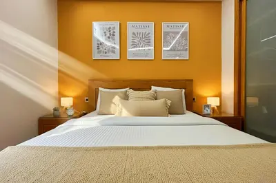 a bedroom with a bed with four pictures on the wall at Maya Suites - Anfa Place - Sea View in Casablanca