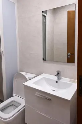 a bathroom with a sink and a toilet and a mirror at Appart luxe in Rabat
