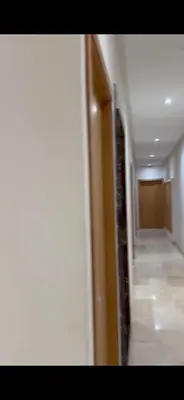 a hallway with a hallway leading to a room at Appart luxe in Rabat