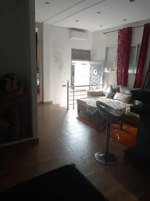 a living room with a couch and a table at Suite in nice résidence in Rabat