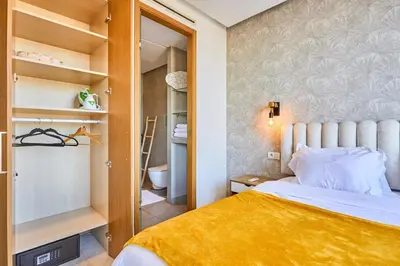 a small bedroom with a bed and a closet at Sunlit loft with terrace-B living 1 Br in Casablanca