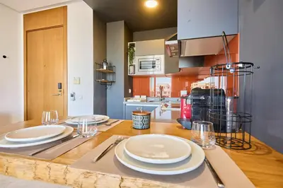 a kitchen with a wooden table with plates on it at Sunlit loft with terrace-B living 1 Br in Casablanca