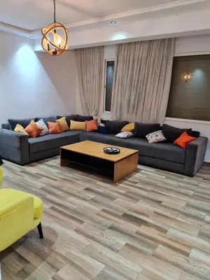 a living room with couches and a coffee table at Adnan in Temara