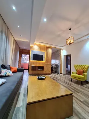 a living room with a couch and a tv at Adnan in Temara