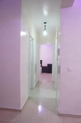 an empty hallway with white walls and a hallway with a room at Modern Apartment in Temara Near Beach & Rabat in Temara