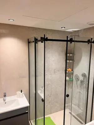 a shower with a glass door next to a sink at Apartment for rent in the heart of Casablanca in Maarif