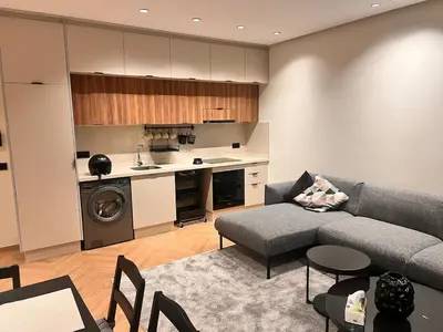a living room with a couch and a kitchen at Apartment for rent in the heart of Casablanca in Maarif