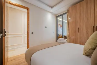 a bedroom with a white bed and a window at New Cosy 1BR Autonome Fibre by- Global Home Stay in Casablanca