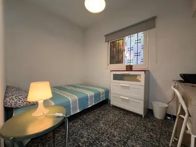 a small bedroom with a bed and a dresser and a lamp at Villa Cosy aux Sablettes, plage à deux pas in Mohammedia
