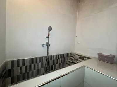a bathroom with a shower in the corner of a room at Villa Cosy aux Sablettes, plage à deux pas in Mohammedia