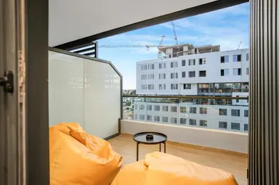 a balcony with a couch and a table at Premium Stay Near Aeria Mall CFC- Feels like Home in Casablanca