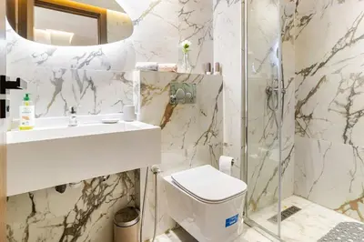 a bathroom with a toilet and a sink and a shower at Appartement de luxe sur la Corniche in Casablanca