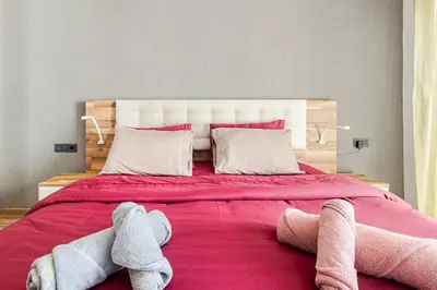 a bedroom with a large bed with a stuffed animal on it at Appartement de luxe sur la Corniche in Casablanca