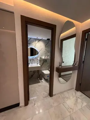 a bathroom with a sink and a toilet and a mirror at Appartement de luxe sur la Corniche in Casablanca