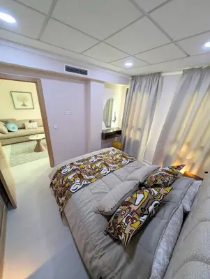 a bedroom with a bed with pillows on it at Comfort & Elegance, Station and Tram Access in Casablanca
