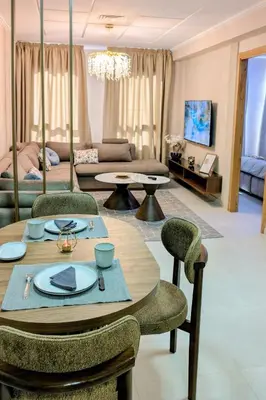 a living room with a table and chairs at Comfort & Elegance, Station and Tram Access in Casablanca