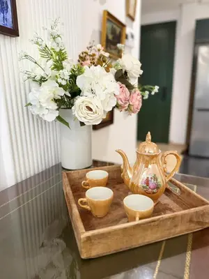 a tray with a tea kettle and cups and flowers at Cosy and charming studio - parking & Terasse in Maarif