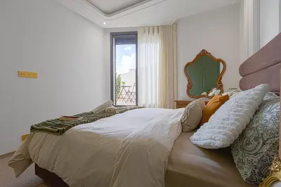 a bedroom with a large bed with a window at Cosy and charming studio - parking & Terasse in Maarif