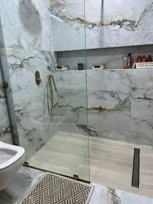 a bathroom with a shower with a glass door at Perle de rabat 2 in Rabat