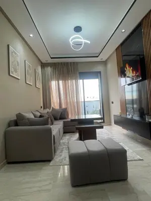 a living room with a couch and a table at Studio cosy au coeur de casa - propre et sécurisé in Casablanca