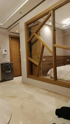 a room with a large glass window and a washing machine at Nice studio for rent in Casablanca