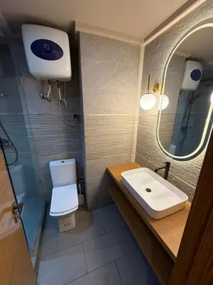 a bathroom with a sink and a toilet and a mirror at Nice studio for rent in Casablanca